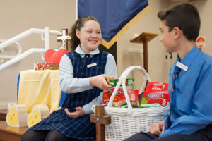 Two students at St Agnes Catholic Primary School Matraville filling hampers for charity