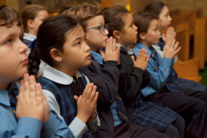 St Agnes Catholic Primary School Matraville students praying in church